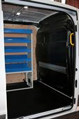 Shelving and a cargo rail in a 2014 Transit fitted out by Syncro North America 